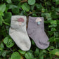 One pair of infant socks (colour and design will vary)