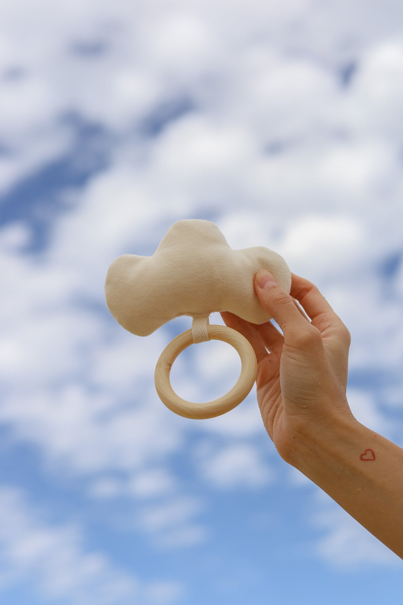 Large soft cream cloud rattle for newborn baby as part of 3-tier Magical Sky nappy cake