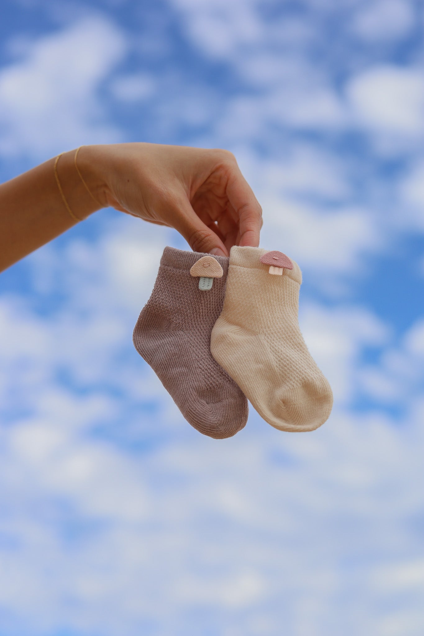 2 pairs of cotton breathable socks for newborn baby as part of 3-tier Magical Sky nappy cake. Colours and design will vary depending on availability.