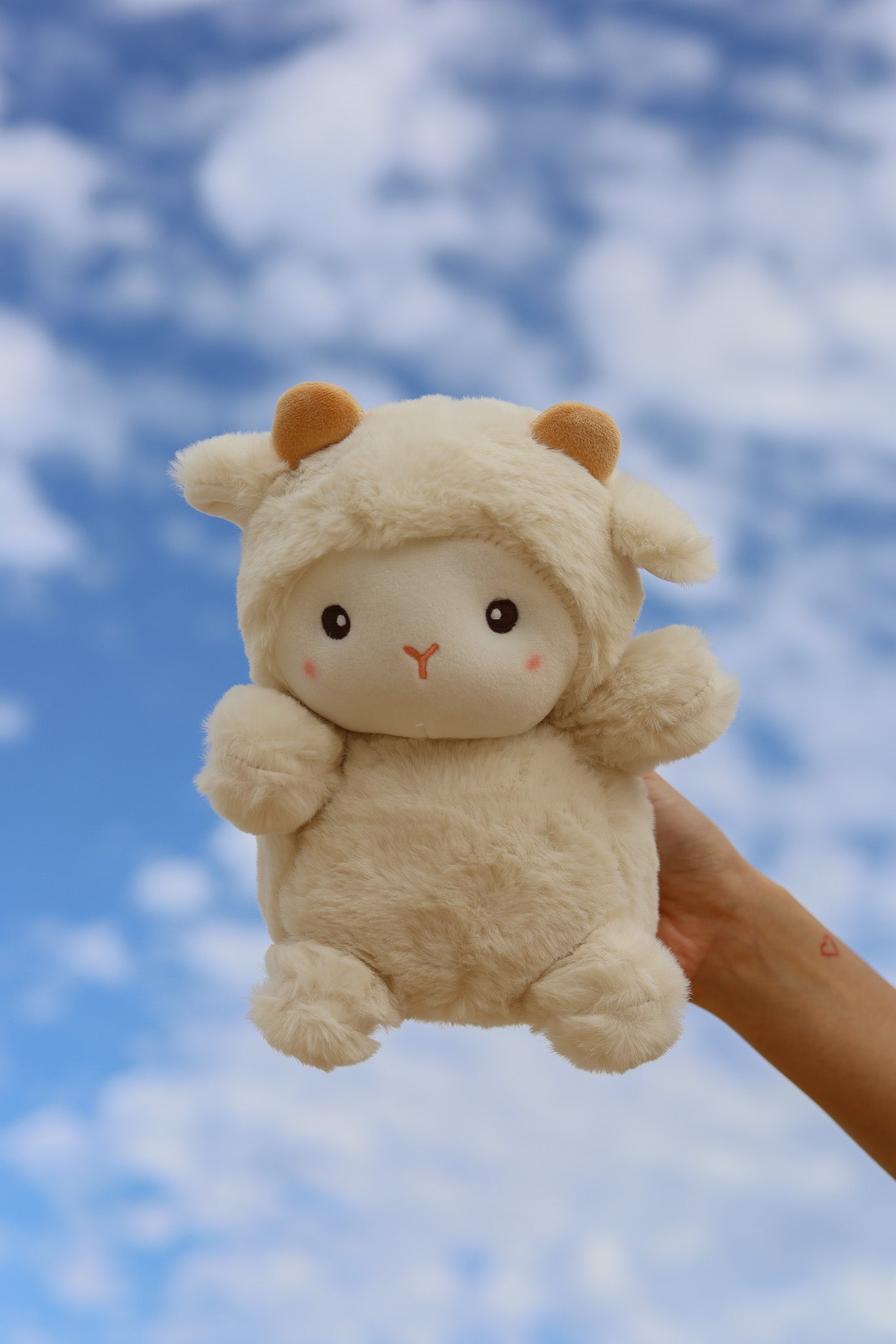 Medium sized plush lamb toy for newborn baby as part of 3-tier Magical Sky nappy cake